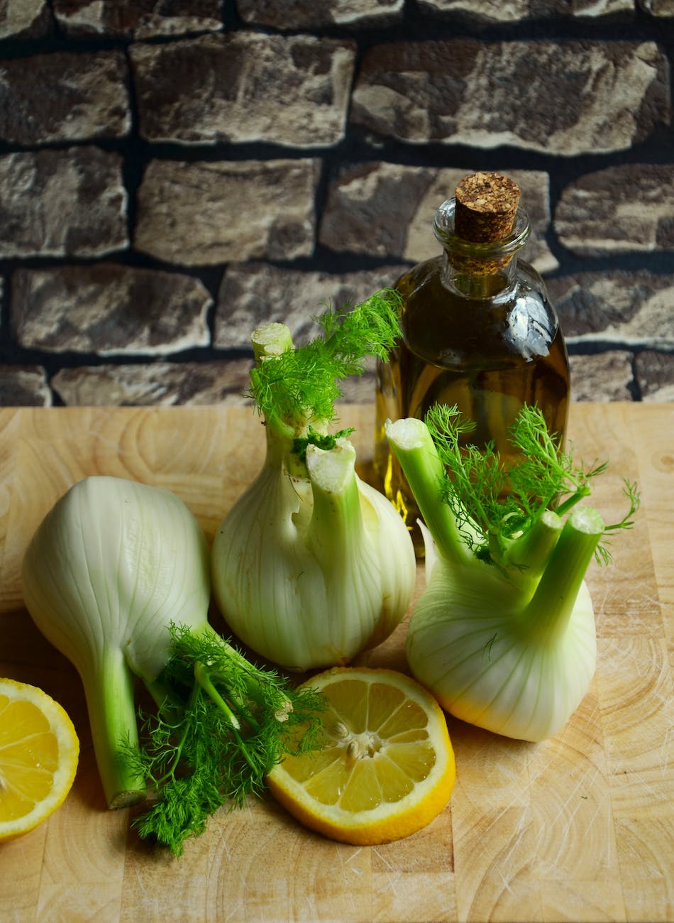 white onion with sliced lemon on beige table