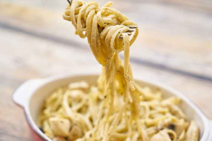 close up photography of pasta with white sauce