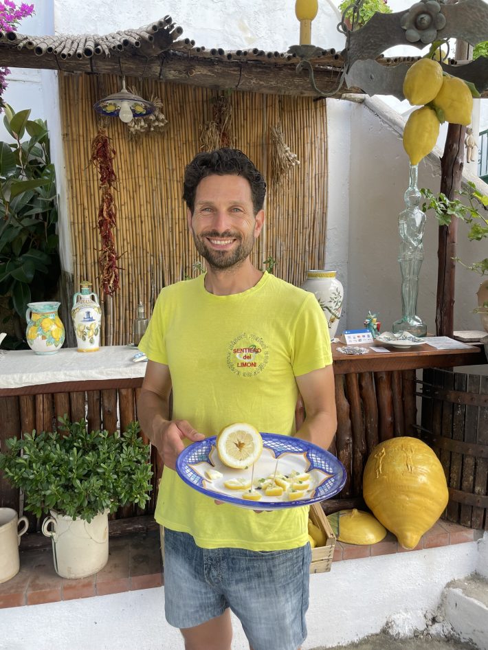 A lemon farmer showing some of his chopped lemons.