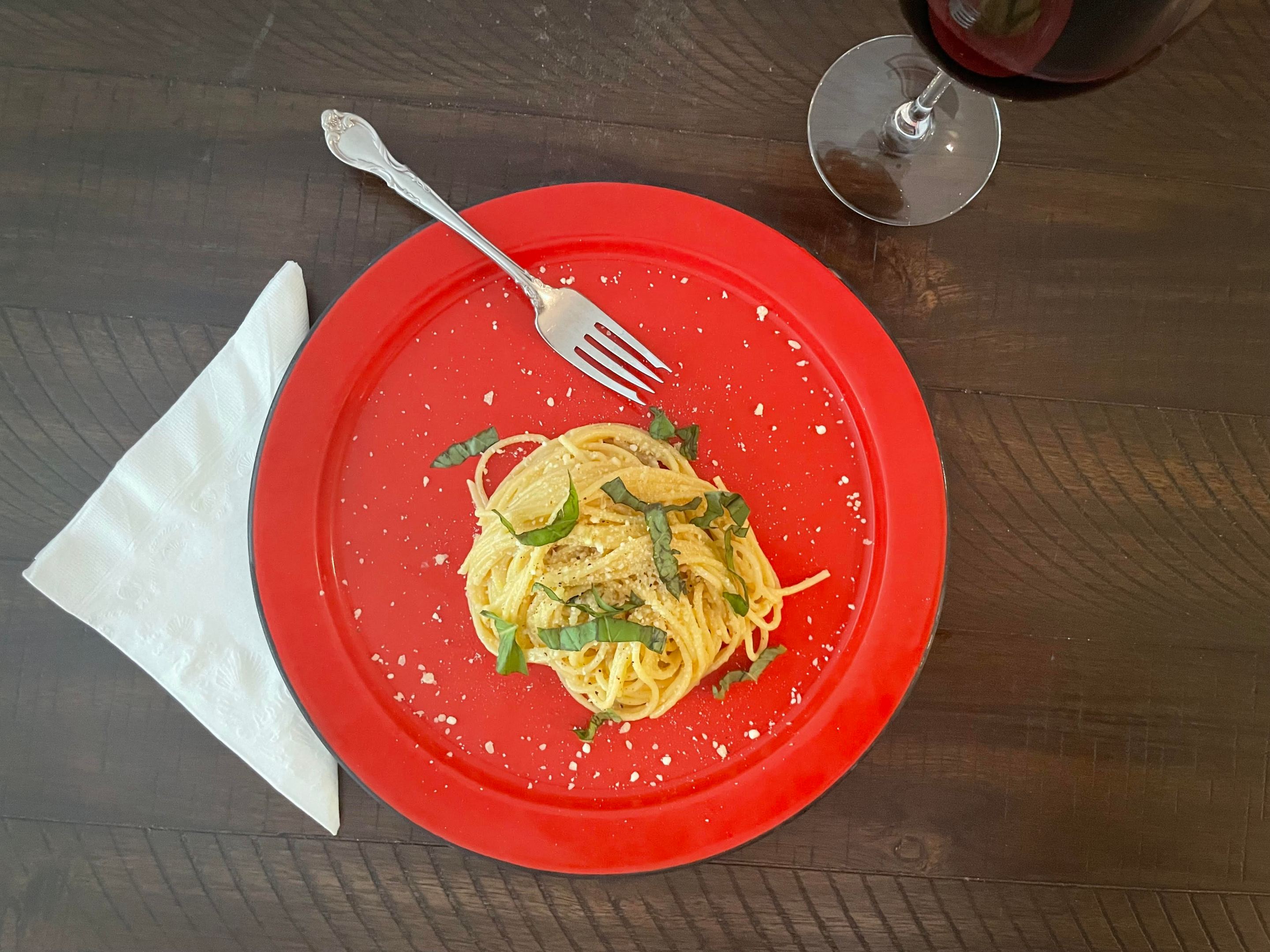 a plate of Pasta al Limone on a wooden table.