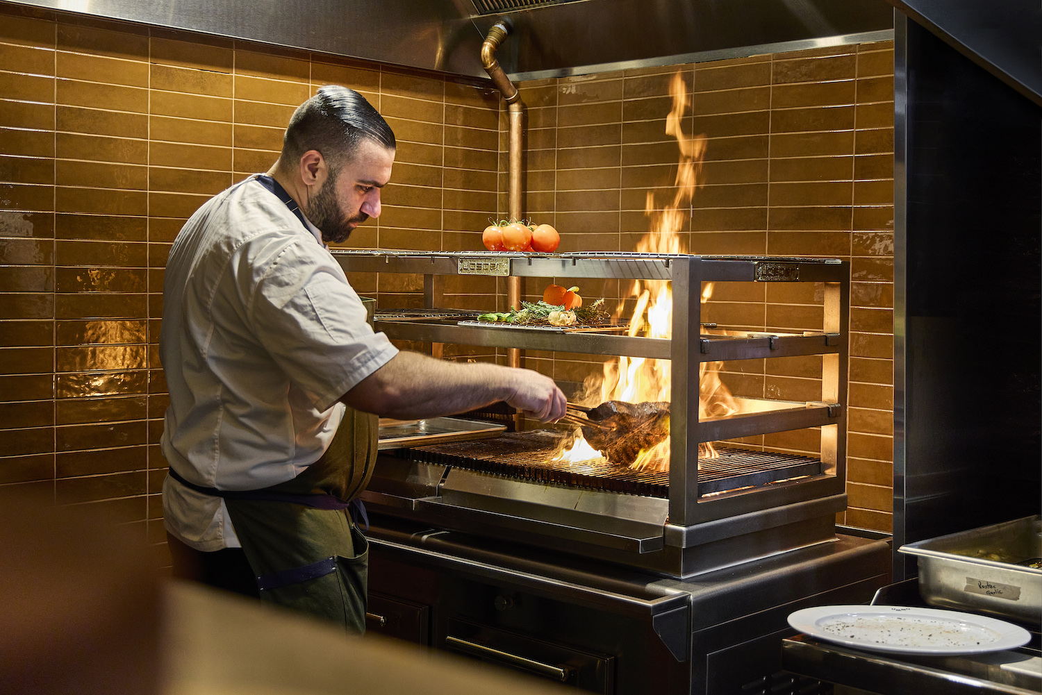 Chef cooking over a flame