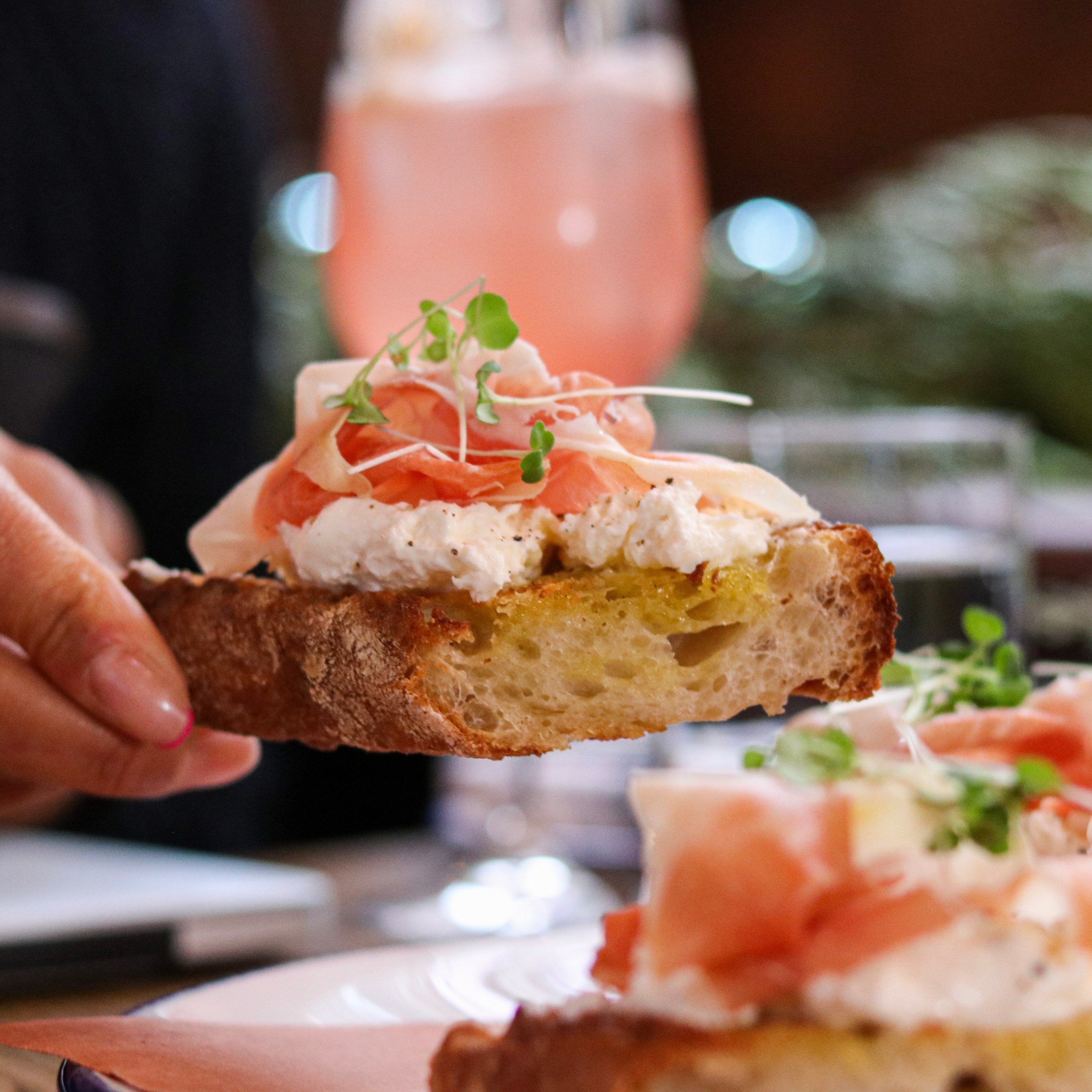hand picking up crostini