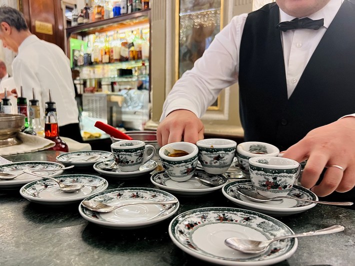 A barista stacking the signature cups at Gran Caffè Gambrinus in Naples.