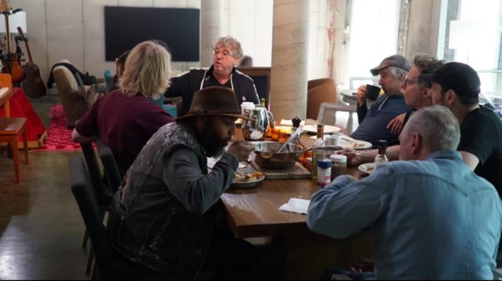 The musicians and producer around the table near Clubhouse Recording Studio.