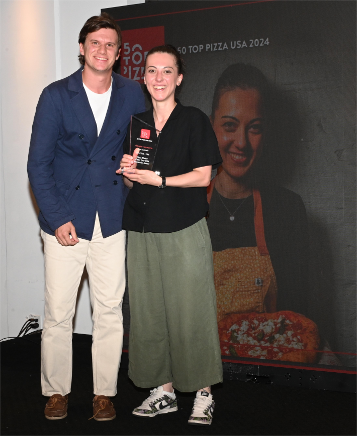 Giorgia Caporuscio accepting her prize as 2024's "Pizza Maker of the Year."