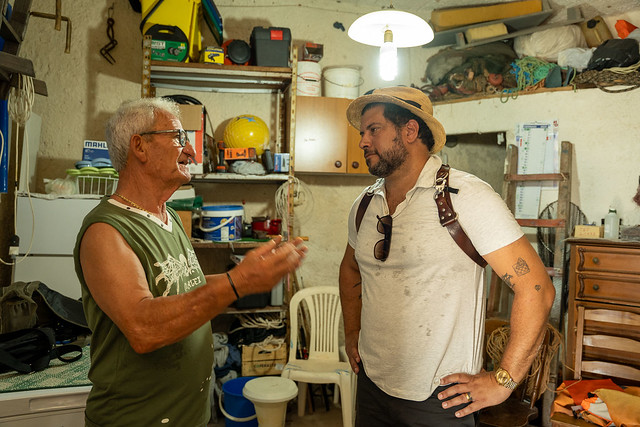 Director Roberto Serrini discusses heritage fishing techniques with last surviving tuna fishermen Salvatore Spataro on the island of Favignana, Sicily.