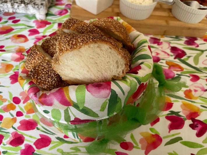 An Italian tablecloth with matching breadbasket.