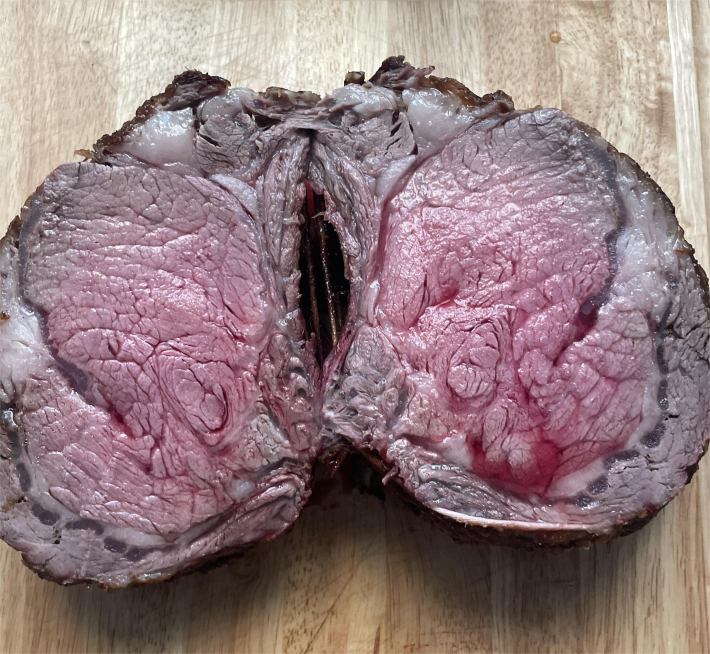 A standing rib roast halved.