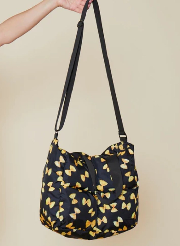 pocketbook with pasta shapes on a black background