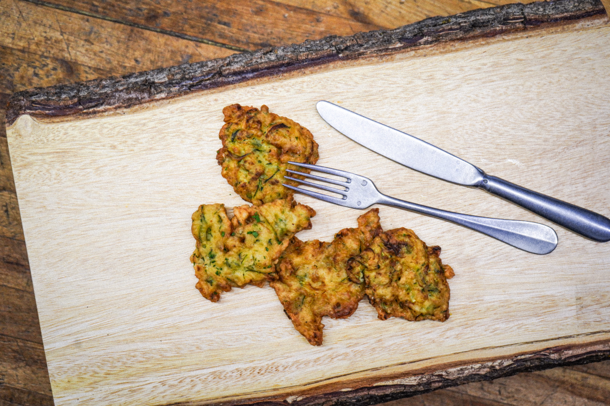 Zucchini fritters with a fork and knife