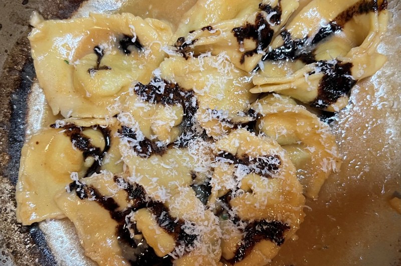 Tortelli Coated in Beef Broth Butter Sauce with Espresso Balsamic Glaze