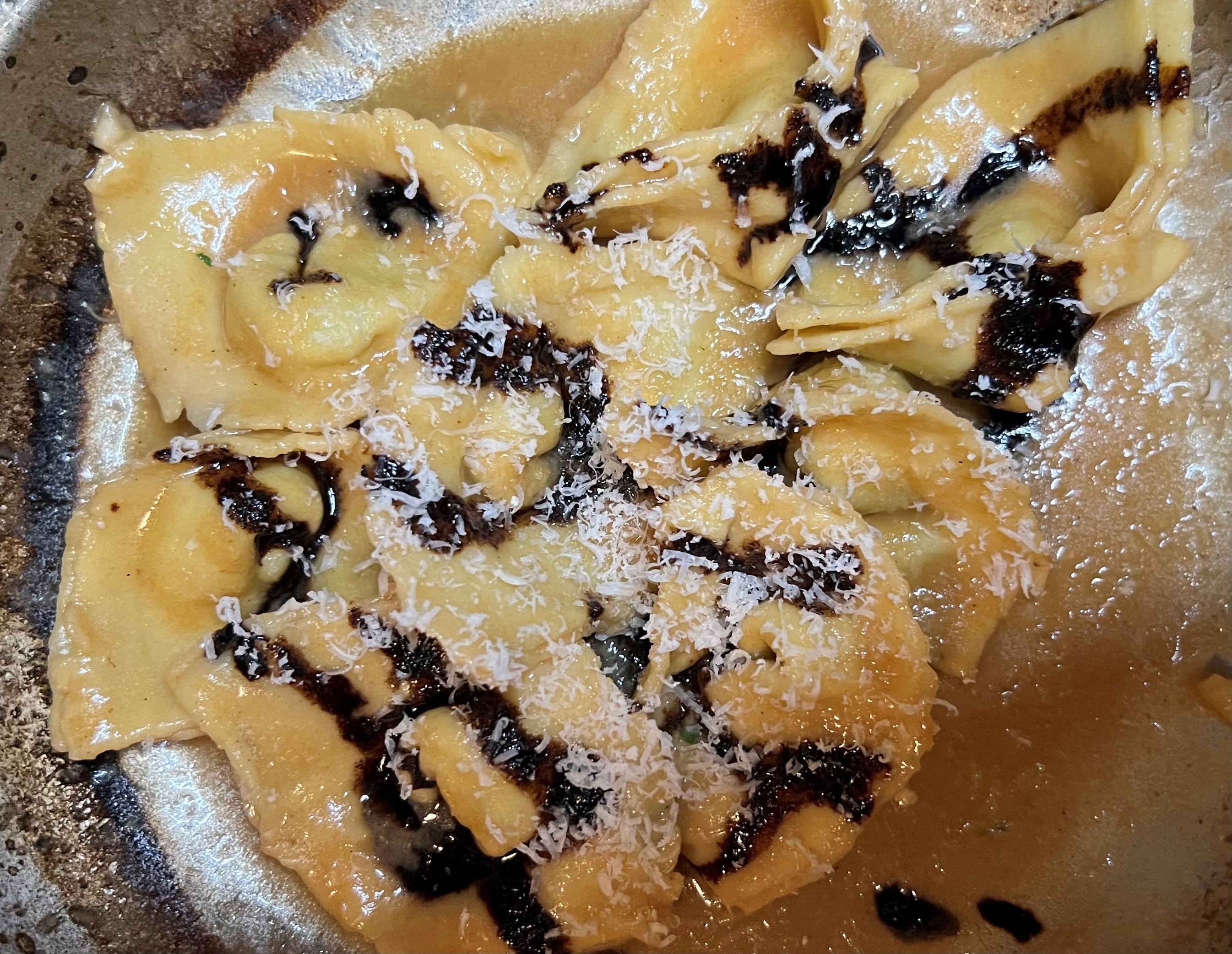 Tortelli Coated in Beef Broth Butter Sauce with Espresso Balsamic Glaze by Alex Palermo.