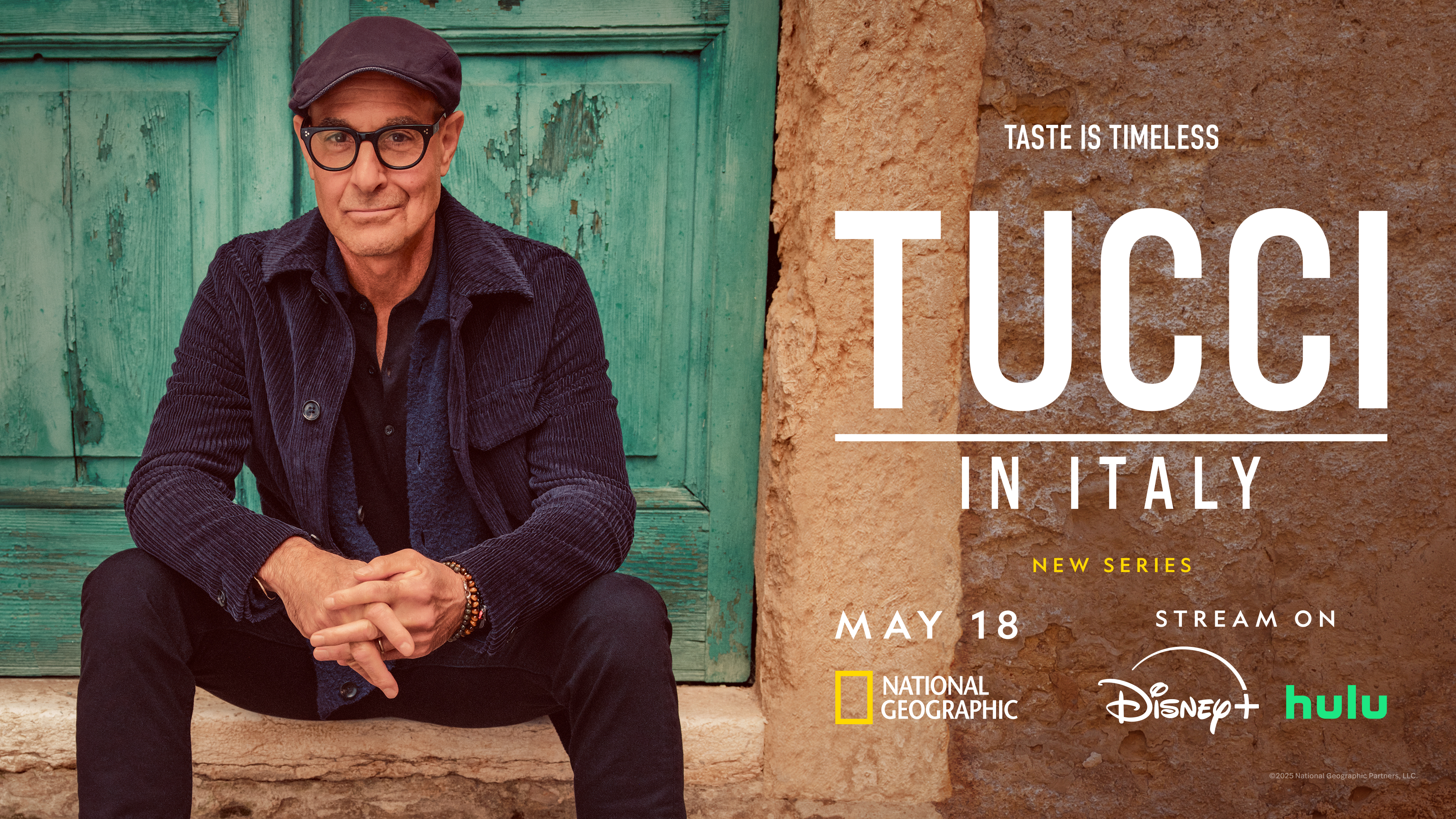 Stanley Tucci wearing a hat, sitting casually on stone steps during filming in Italy.