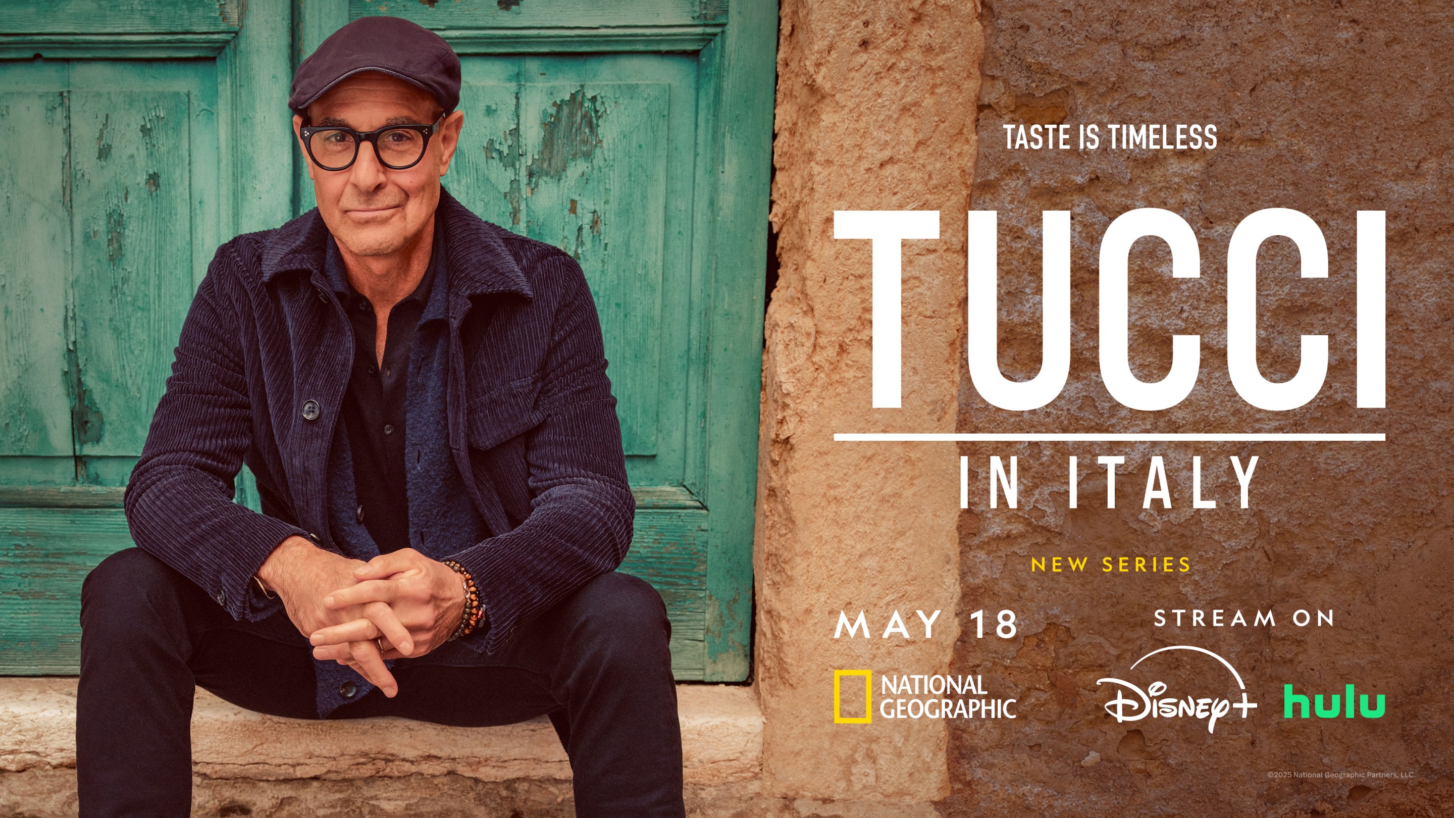 Stanley Tucci wearing a hat, sitting casually on stone steps during filming in Italy.