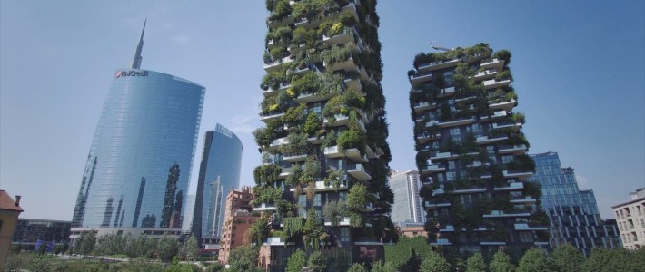 A wide shot of the Bosco Verticale towers in Milan’s Porta Nuova district, covered in greenery.