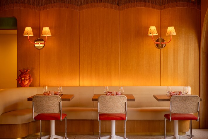 Cozy dining nook with wood paneling and warm lighting inside Alba restaurant.