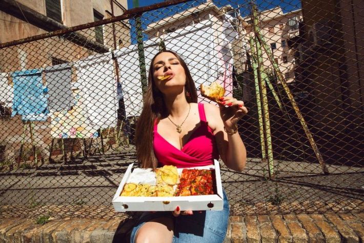 The Pasta Queen enjoying pizza in her hometown of Rome. Photo by Erica Fava.