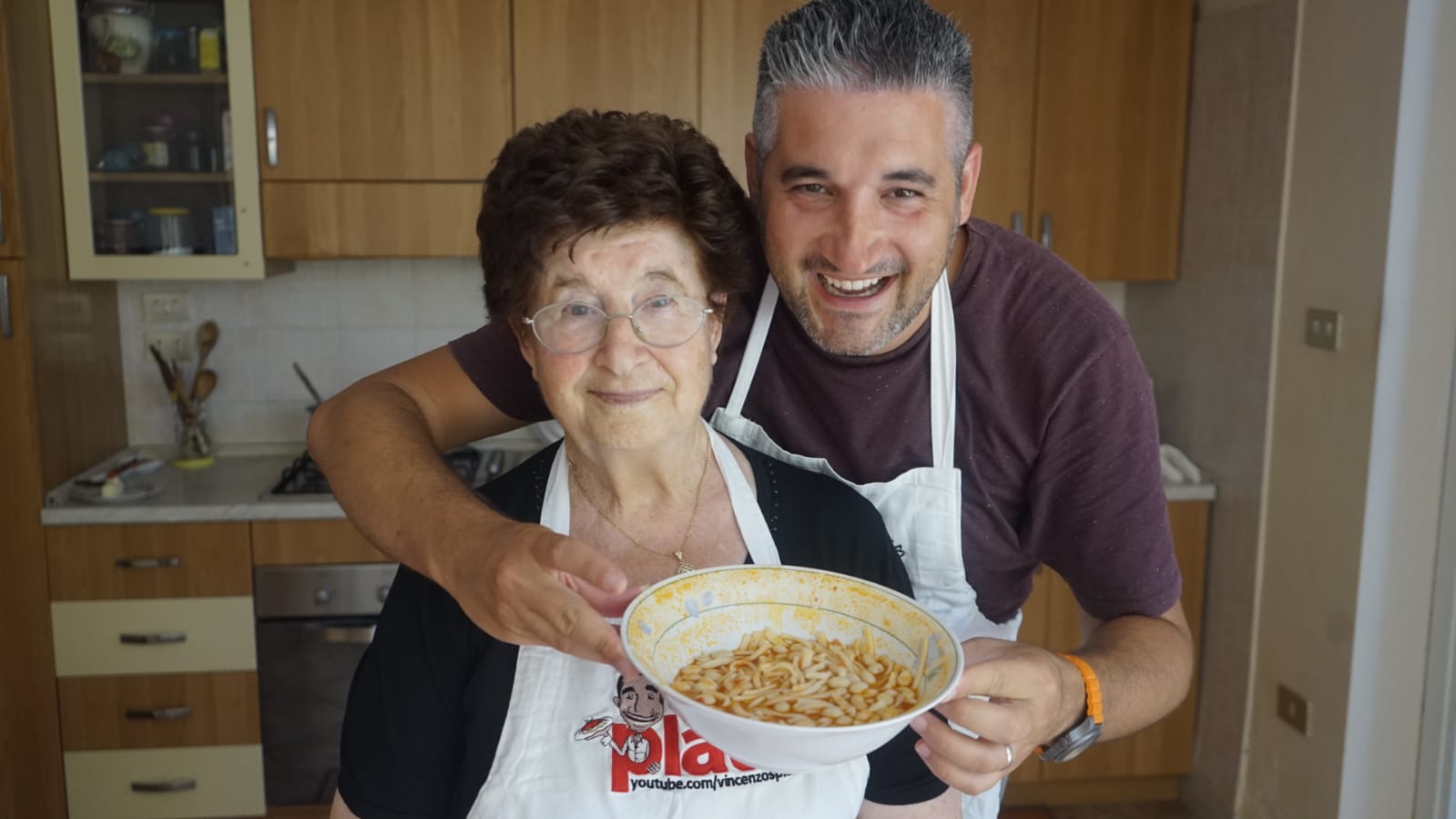 Vincenzo Prosperi with his Nonna holding a bowl of homemade pasta.