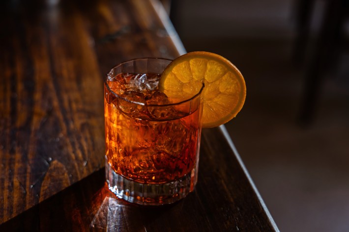 Sicilian aperitivo cocktail with orange garnish.