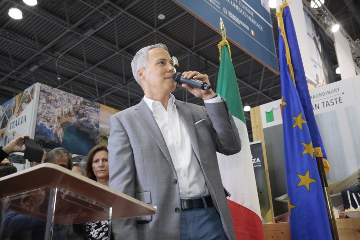 Official speaking at ribbon-cutting ceremony in the Italian Pavilion