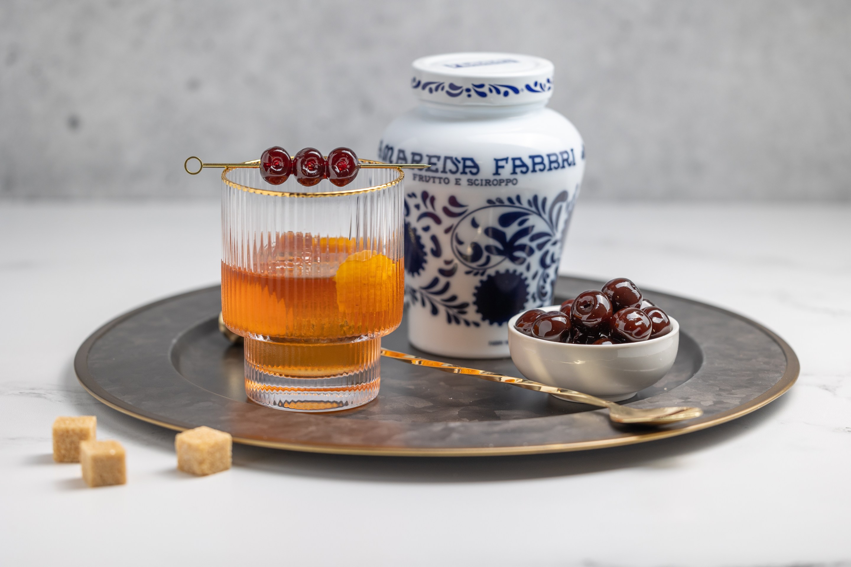 The Amarena Old Fashioned with Fabbri cherries and ceramic jar.