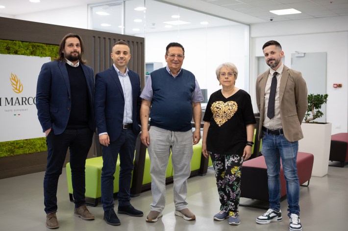 Group photo of the Di Marco family in company headquarters