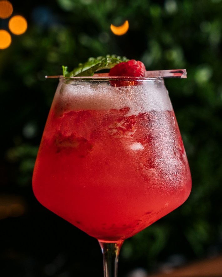 Close-up of a raspberry cocktail garnished with mint at Serafina Miami.