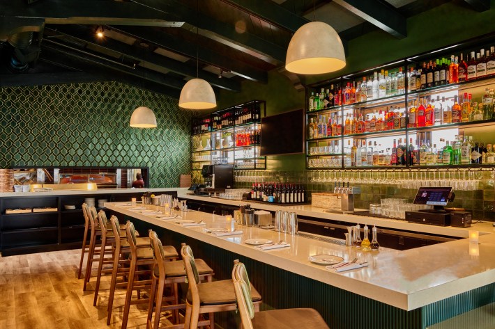 Bar area at Piatti Laguna Beach with green tile and pendant lights