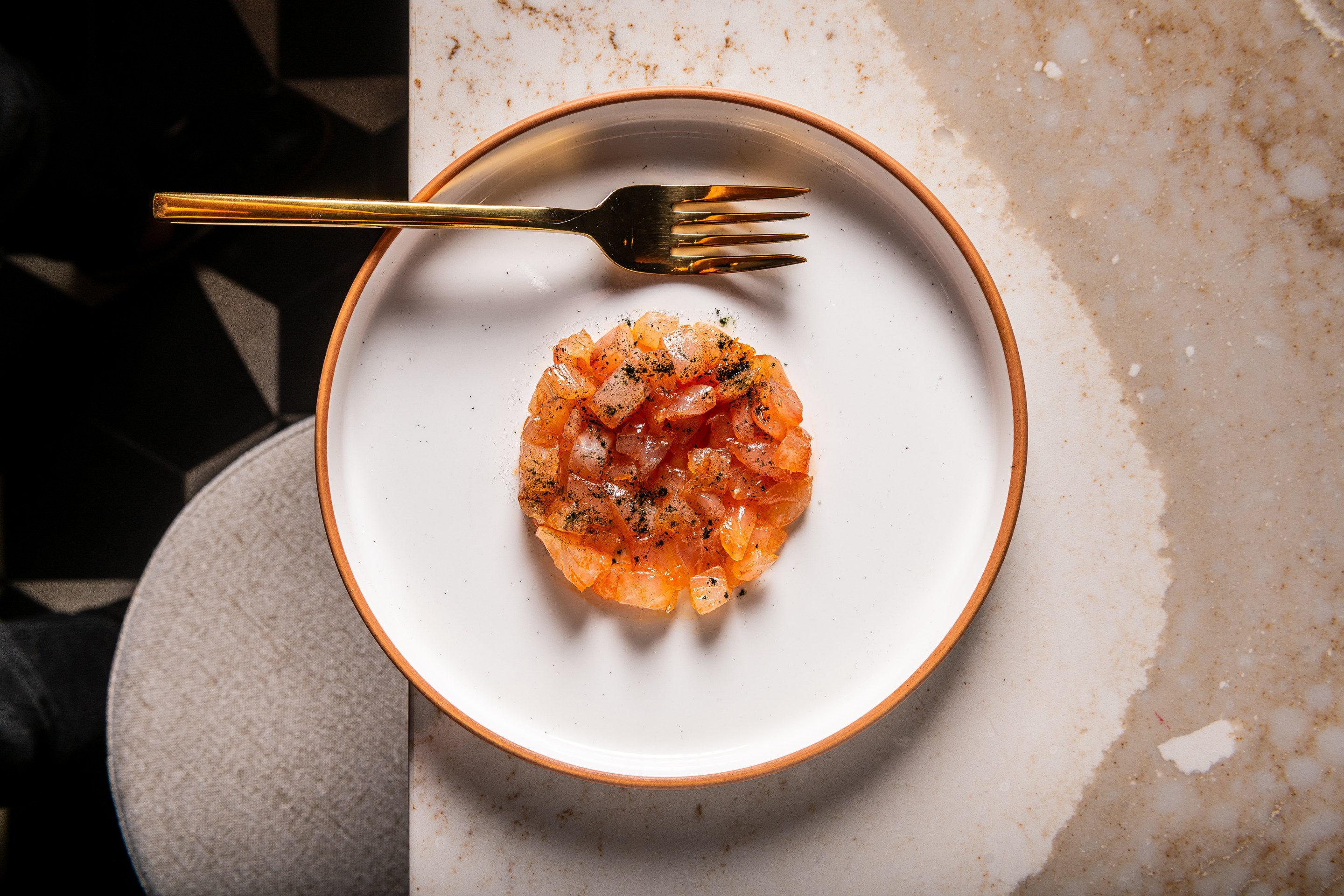 Plate of finely diced seafood tartare with light seasoning