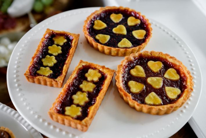 Crostate with heart and flower pastry cutouts on a white serving plate
