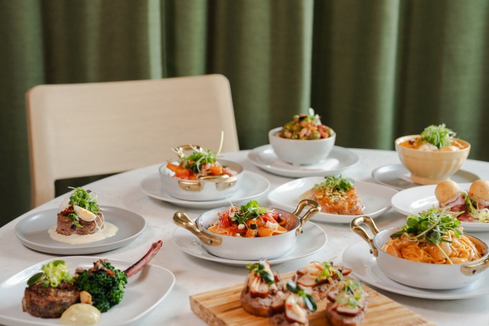 Assorted cicchetti dishes on white marble table at L’Olivo
