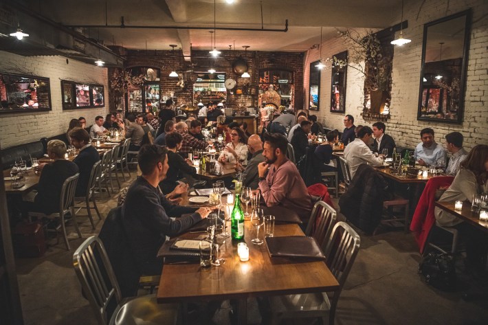 Guests dining at Peasant during a busy evening