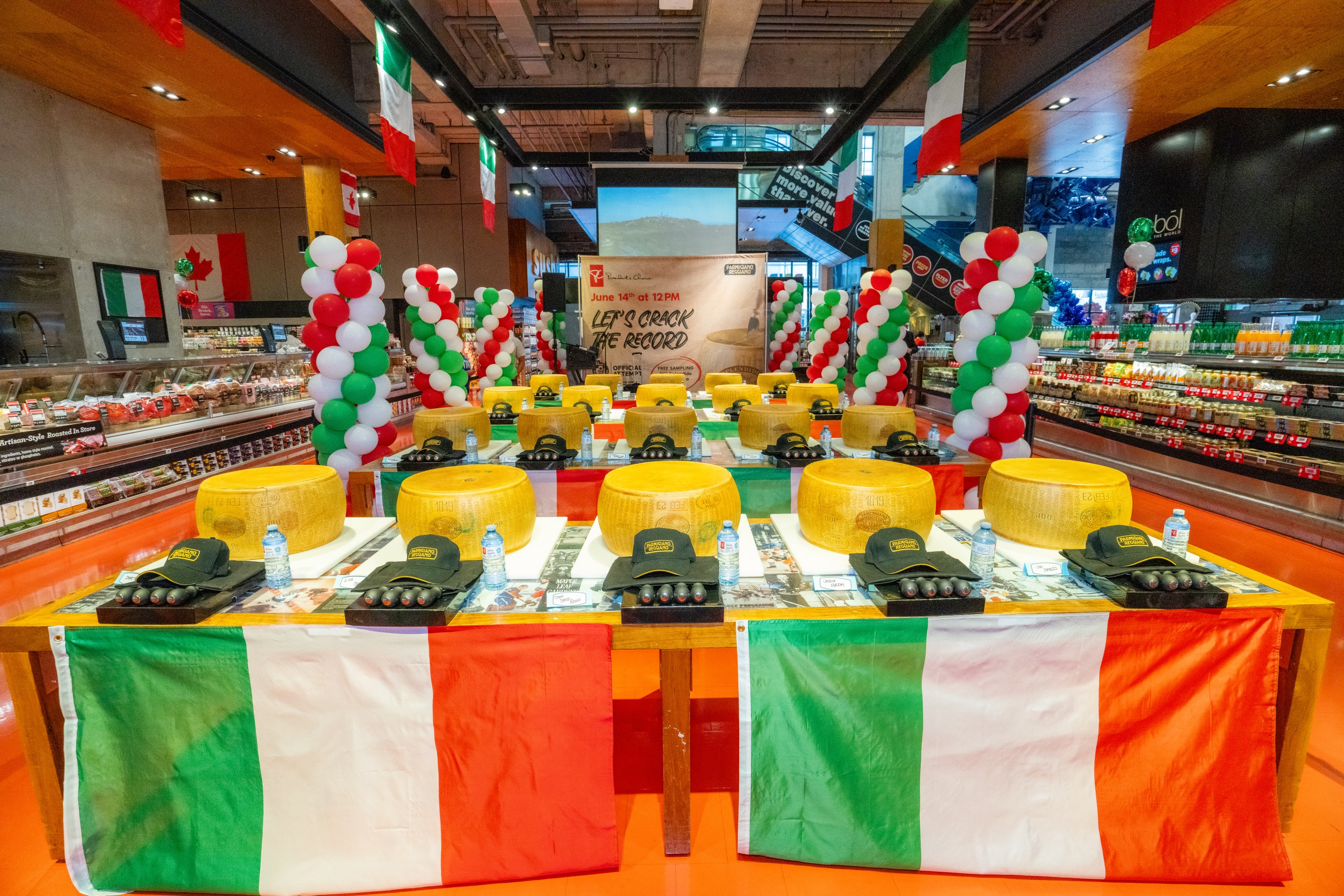 Tables lined with Parmigiano Reggiano wheels and Italian flags at Loblaws Toronto