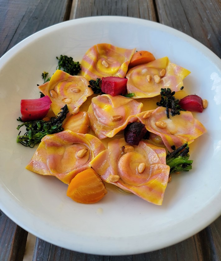Handmade beet-infused cappelletti pasta with broccolini and pine nuts