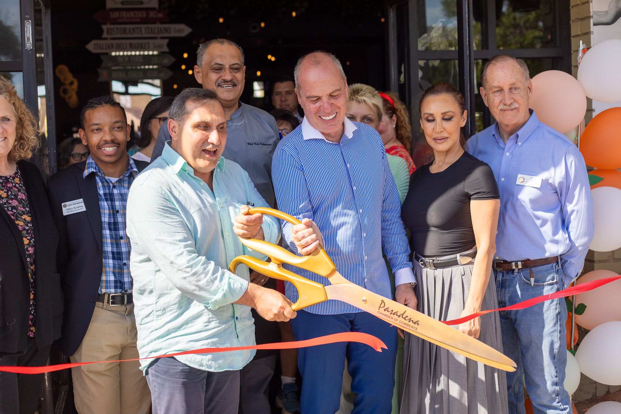 Community leaders and owners cut the ribbon at The Italian Deli Co. grand opening in Pasadena.