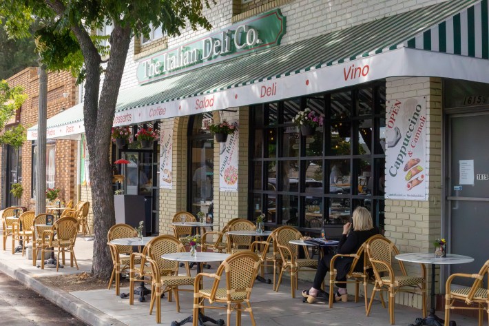 Outdoor seating at The Italian Deli Co. in Pasadena with tables set along East Washington Boulevard.
