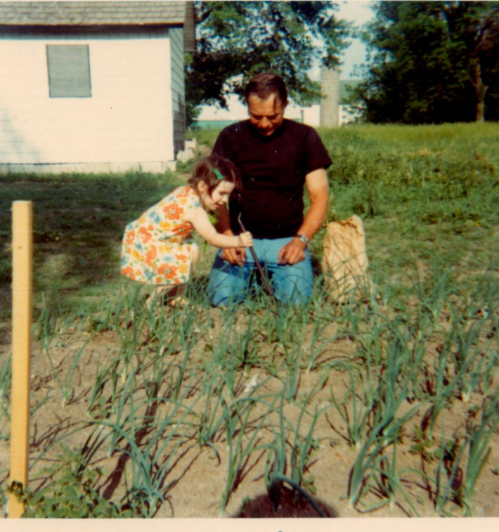 A young Christine Dimmick picking onions at her grandparents' farm.