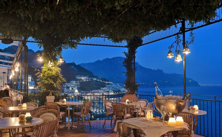 Dusk at La Terrazza, with tea lights in backgroun and tables set for dinner.