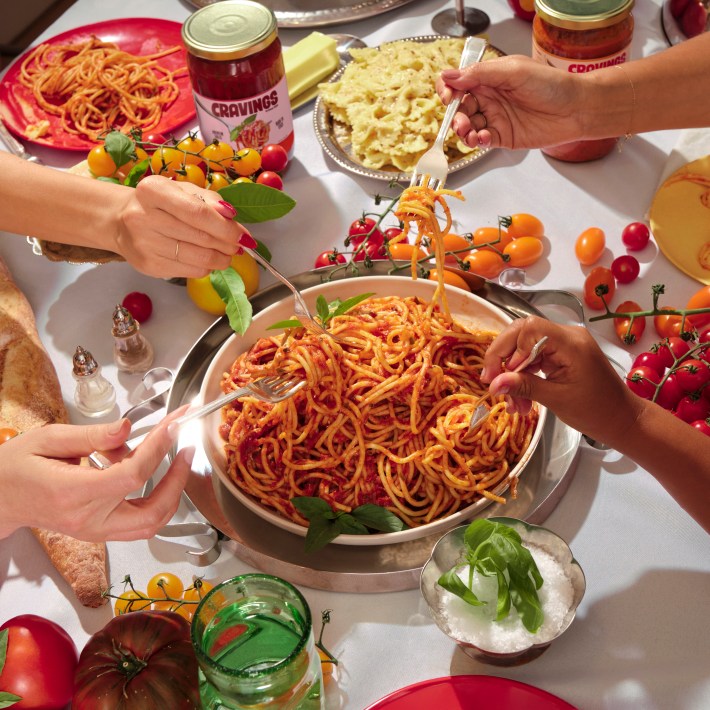 able filled with Cravings pasta sauces, spaghetti, tomatoes, and herbs
