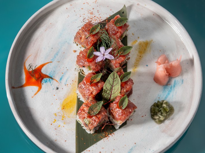 Plated dish of sushi-style rolls with garnishes and colorful presentation at Senzafine.