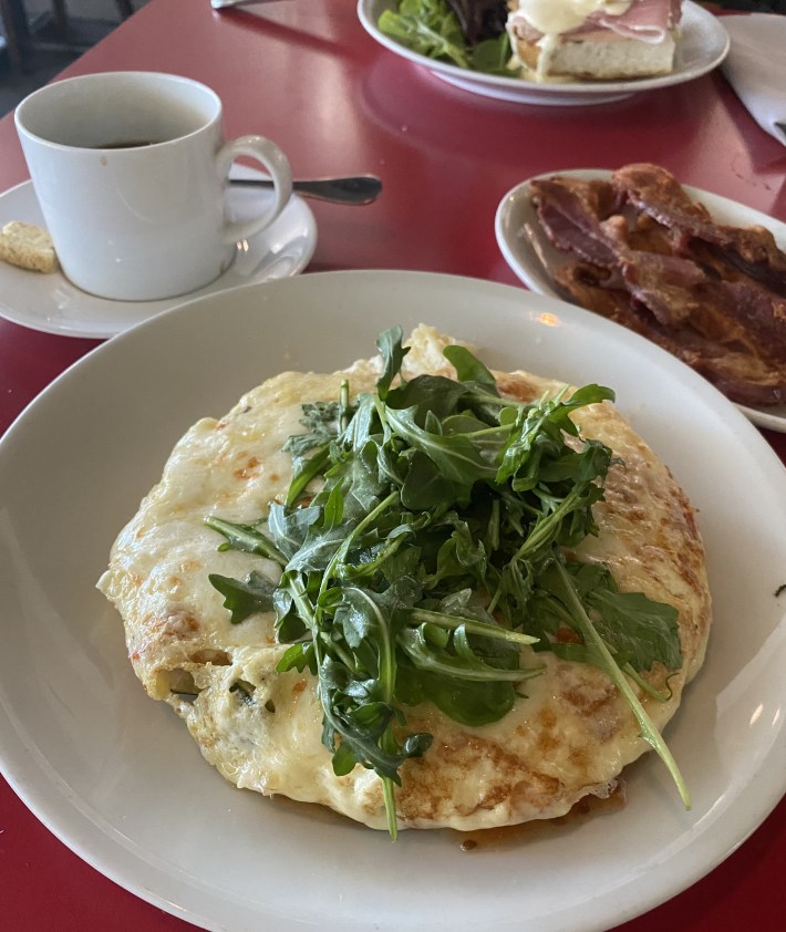 Egg white frittata with arugula served alongside bacon and coffee at Asti