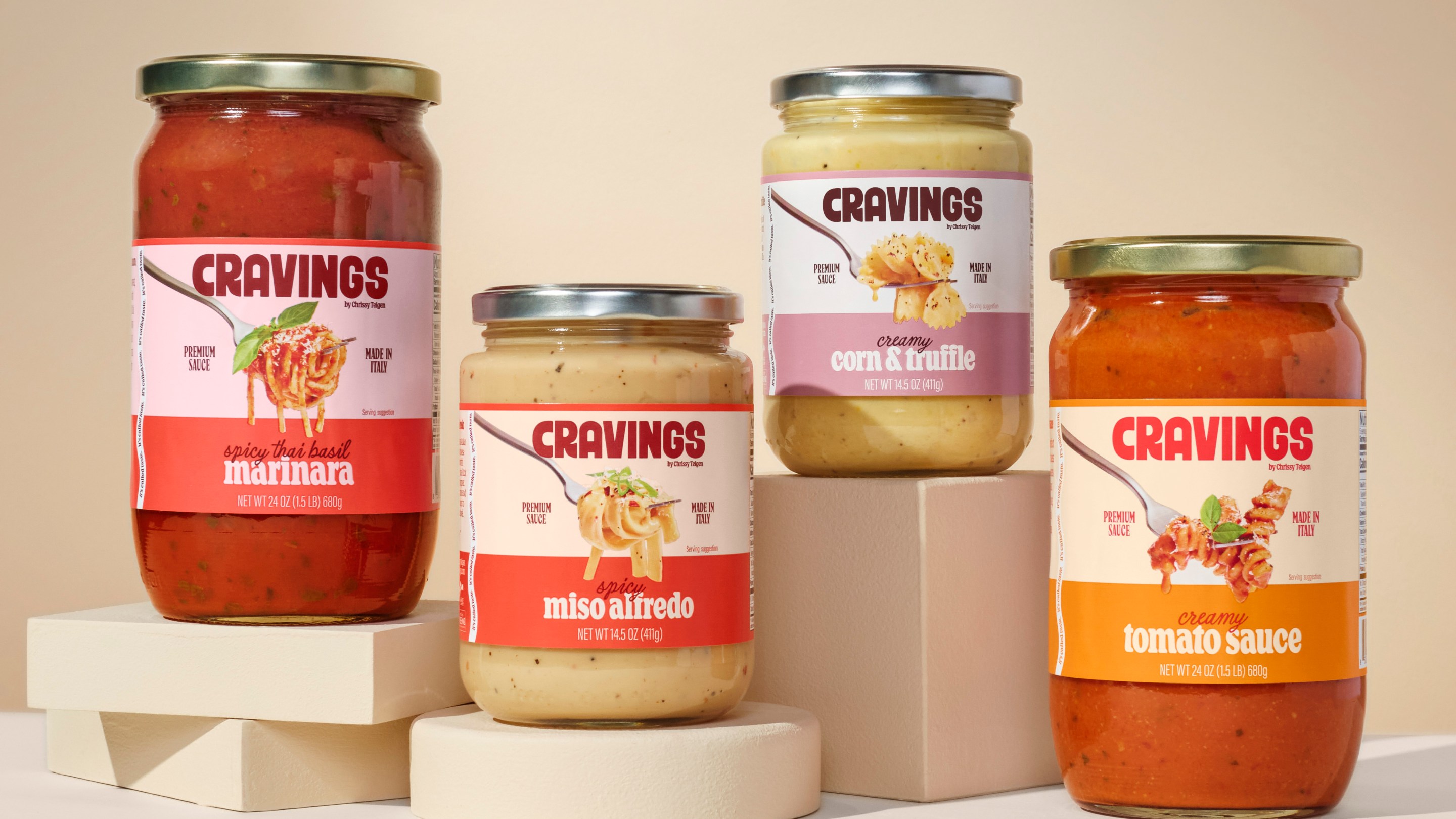 All four jars of Chrissy Teigen’s Cravings pasta sauces on a neutral backdrop