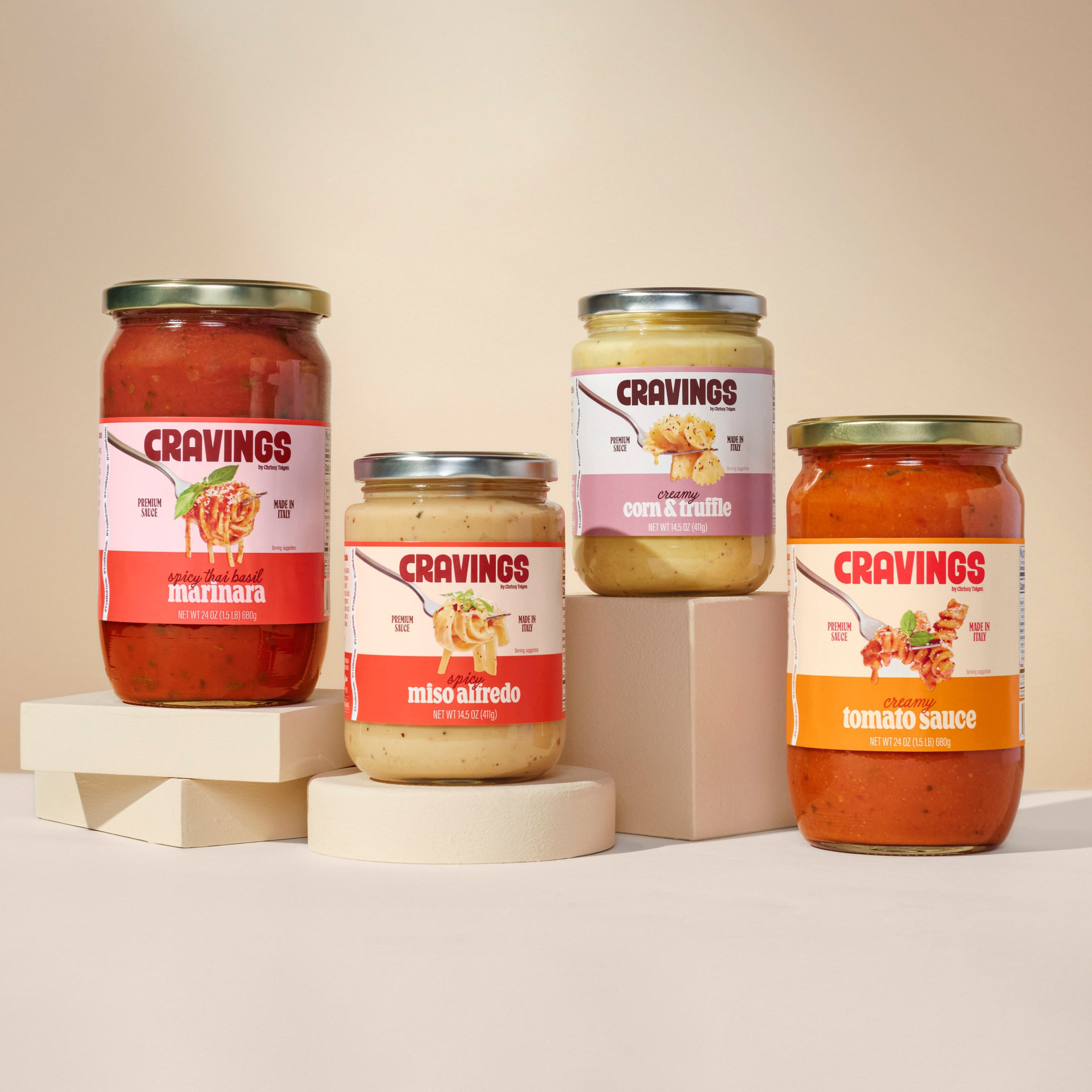 All four jars of Chrissy Teigen’s Cravings pasta sauces on a neutral backdrop