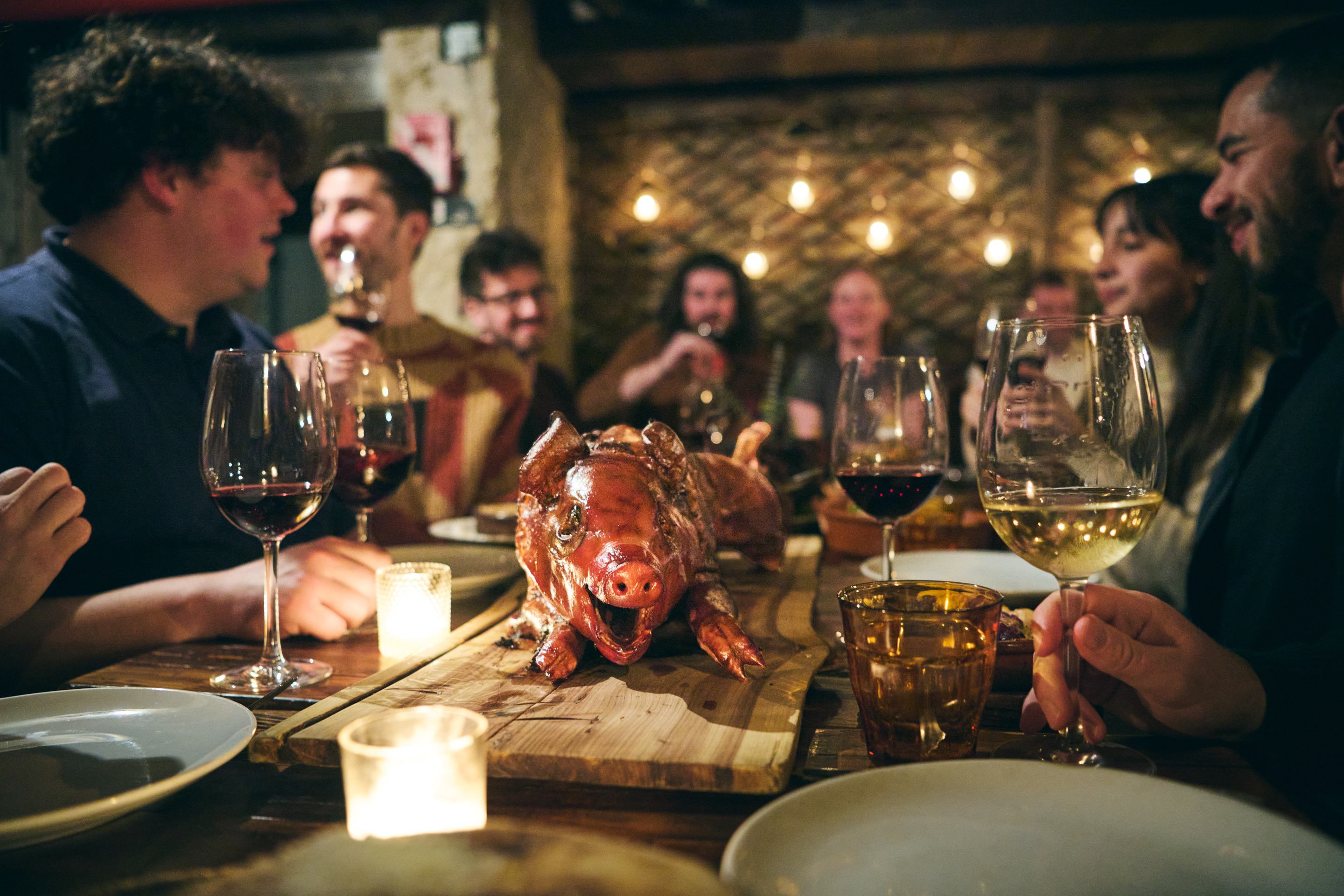 Rotisserie roasted pig resting on a tray at Peasant