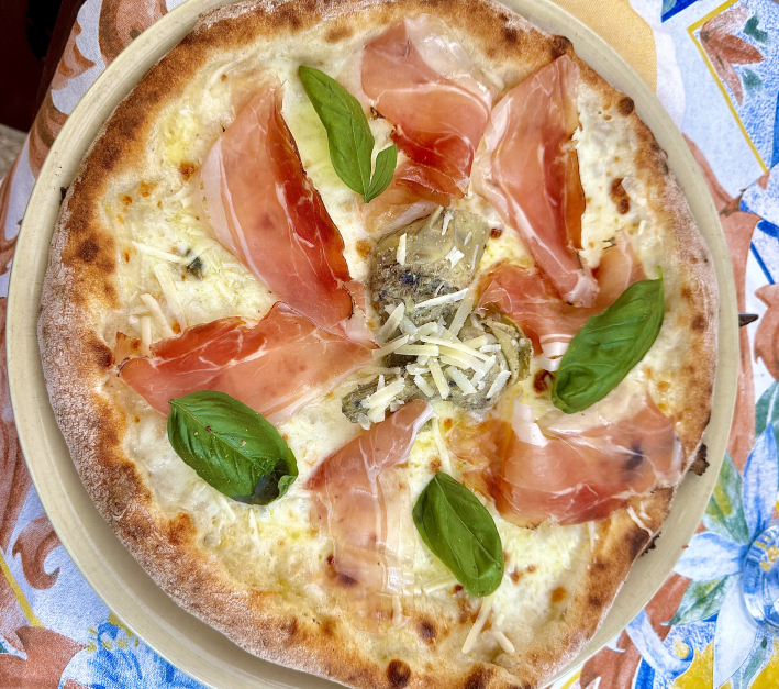 Geta pizza topped with Tramonti Fior di Latte, provola, grilled artichokes, speck, and pecorino.