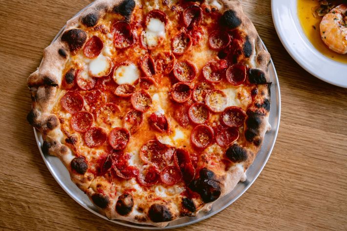 Close-up of Flour + Water’s pepperoni pizza with golden crust