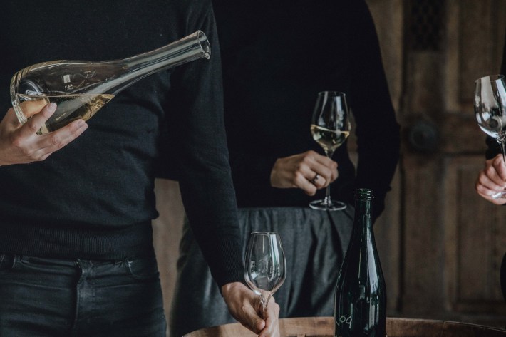 Pouring Champagne Telmont into glasses at a tasting