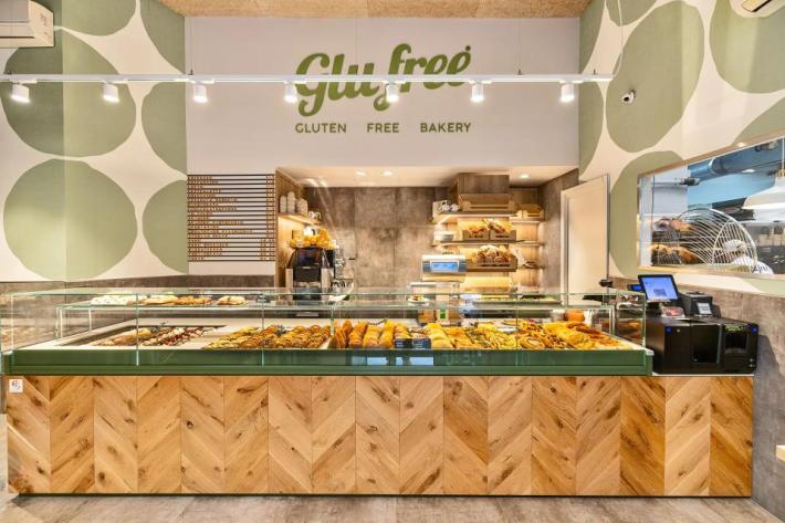 Inside Milan's GluFree Bakery, with glass cases showing off their fresh pastries.