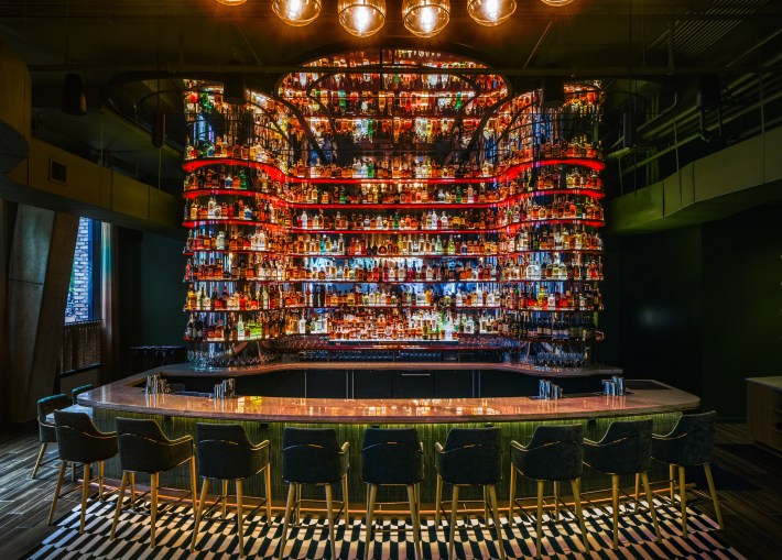 Acqua Bistecca’s glowing bar with floor-to-ceiling bottles in Washington DC.