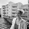 Black and white photo of Margaret Ross with buildings in the background.